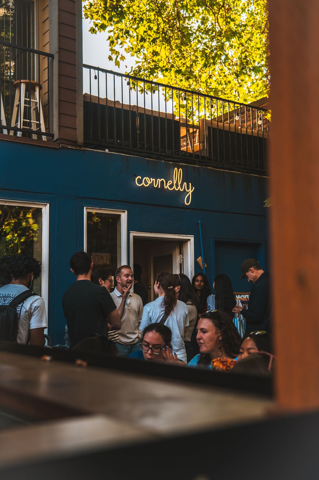 City photo — crowd gathered outside Cornelly on the patio
